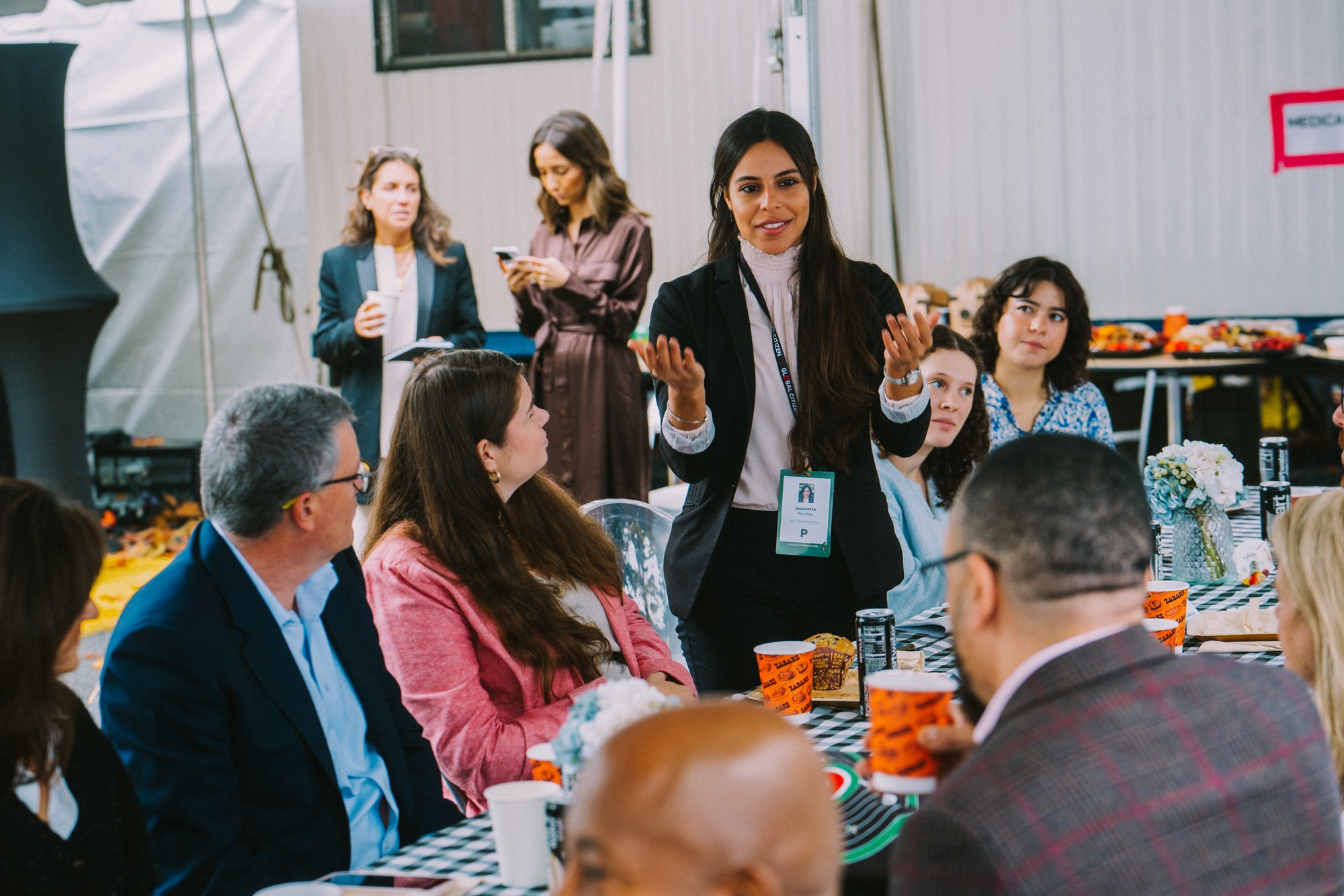 Jeannette Paulino leading a discussion with partners around a table